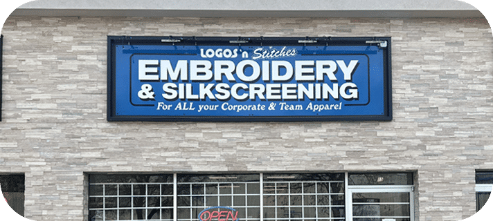 Storefront view of Logos N Stitches, showcasing the entrance and signage of the embroidery and printing shop